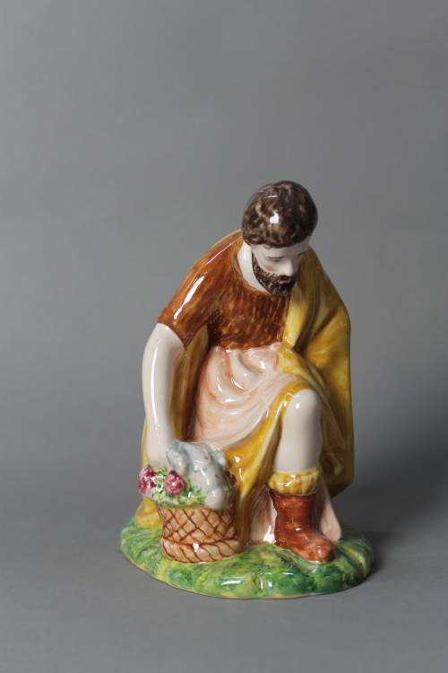 Kneeling shepherd with basket. Large, coloured figure.