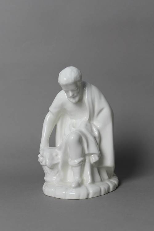 Kneeling shepherd with basket. Large, white glazed figure.