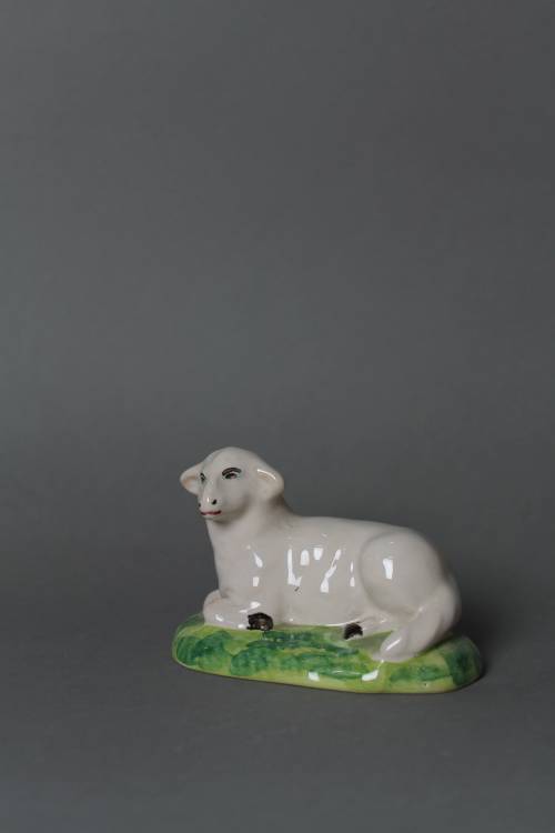 Lying sheep. Large, coloured figure.
